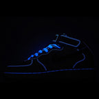 Dark blue sneaker with glowing blue outline and lace-up silhouette