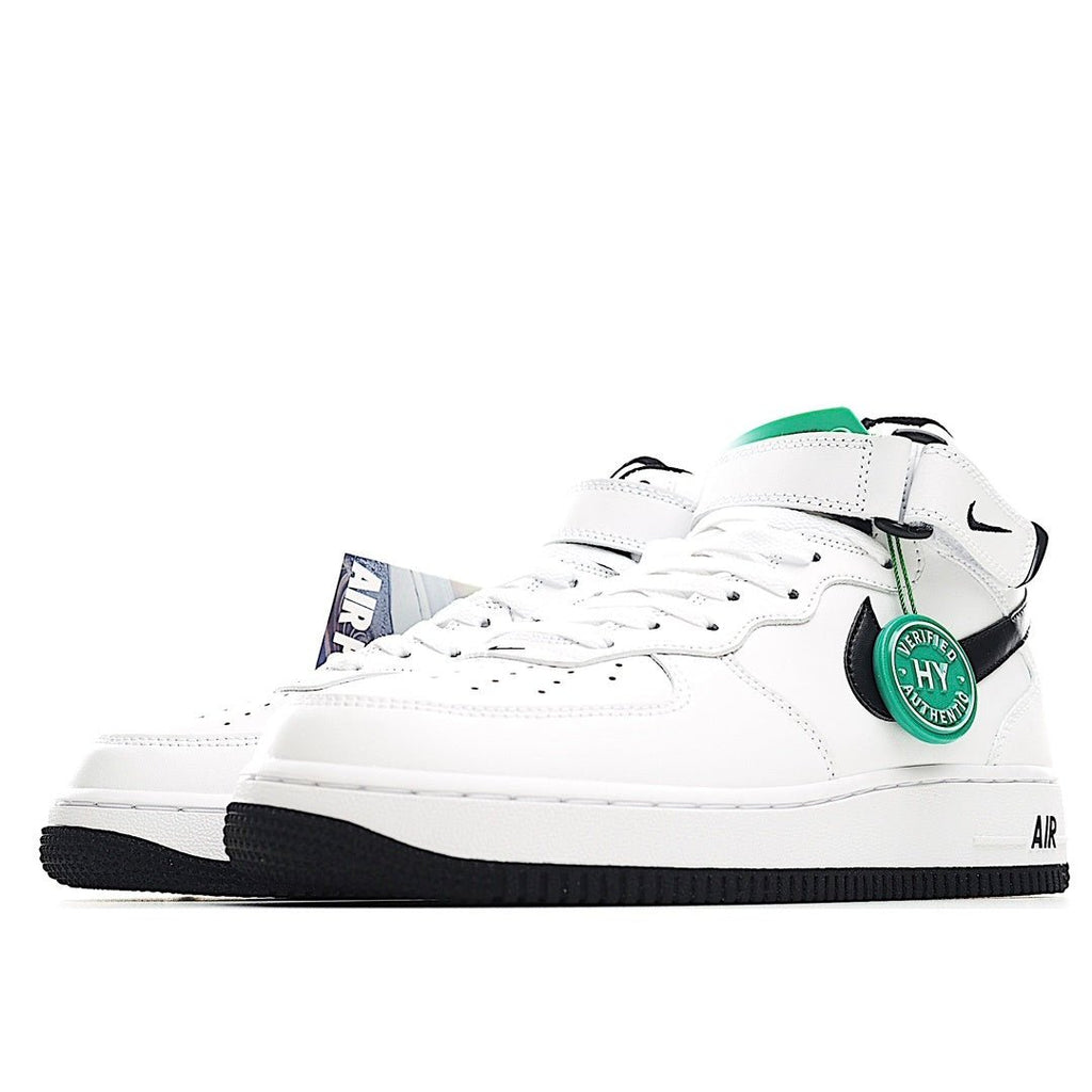 White low-top sneakers with black swoosh, green accent tag, and black outsole