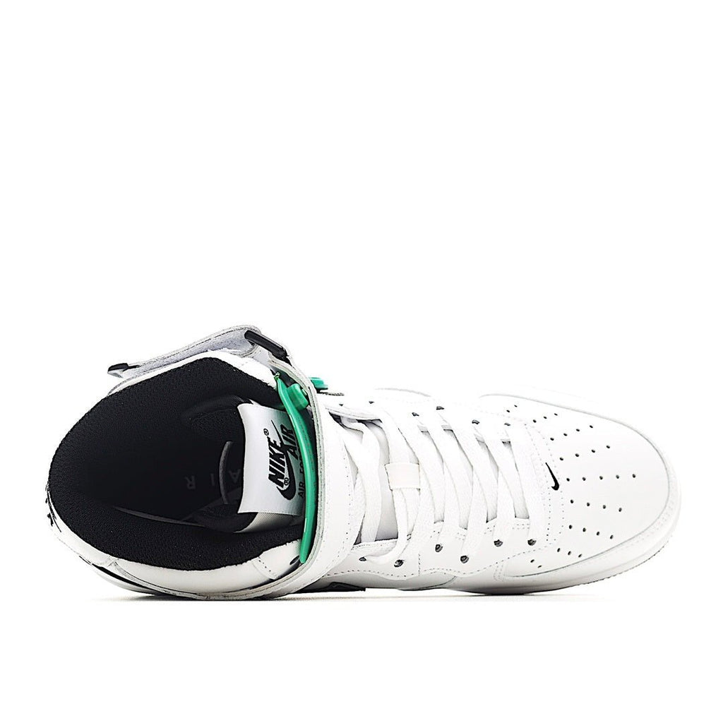 White low-top sneakers with black interior lining and green lace detail