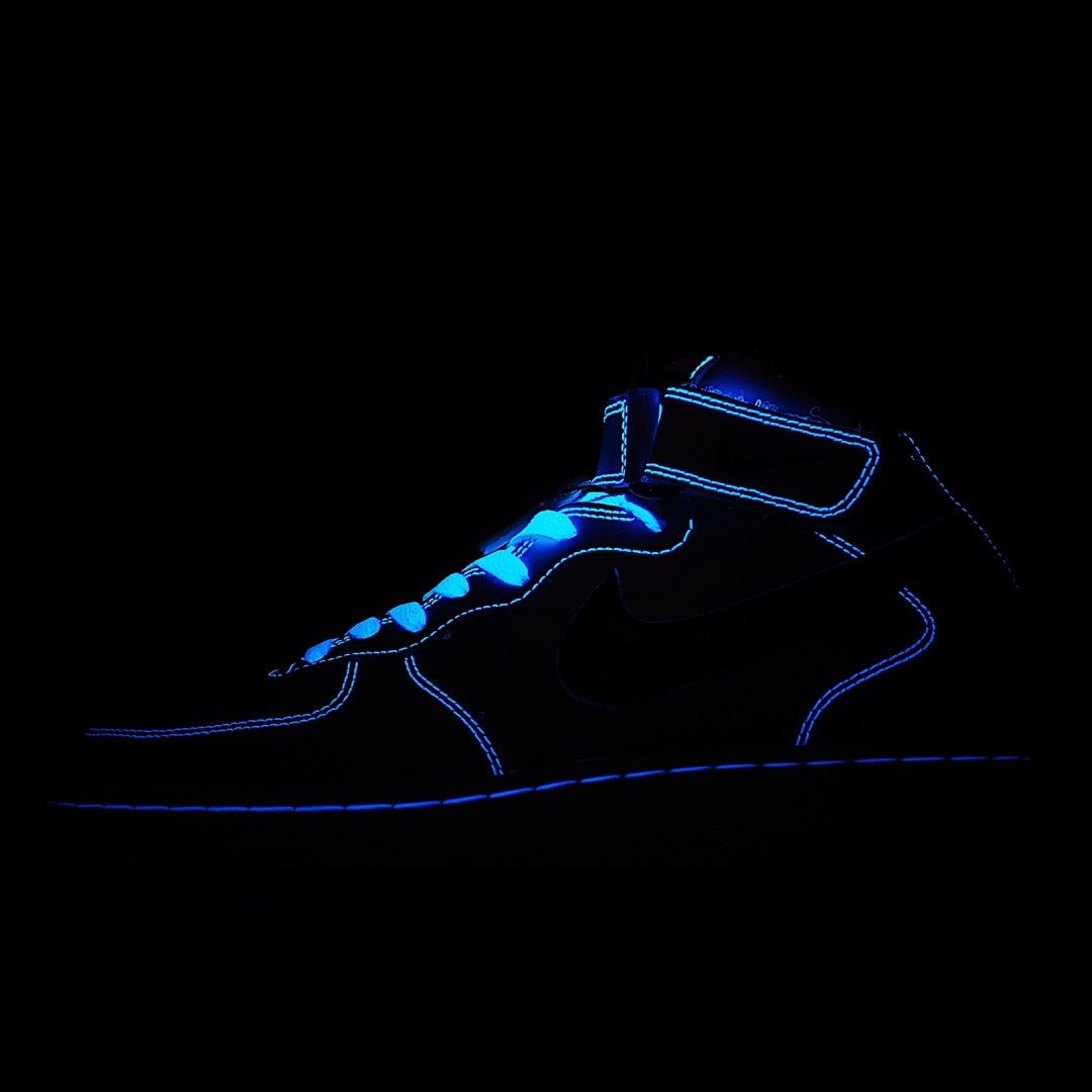 Dark blue and black high-top sneakers with neon blue outline and swoosh detail