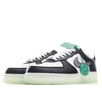 White and black low-top sneaker with teal lace tag, Swoosh logo, light-olive sole