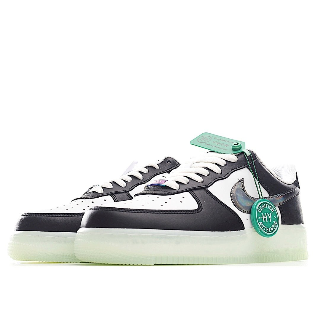 White and black low-top sneaker with teal lace tag, Swoosh logo, light-olive sole