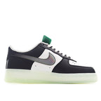 Black and white low-top sneaker with teal lace tab, side Swoosh, light-olive sole
