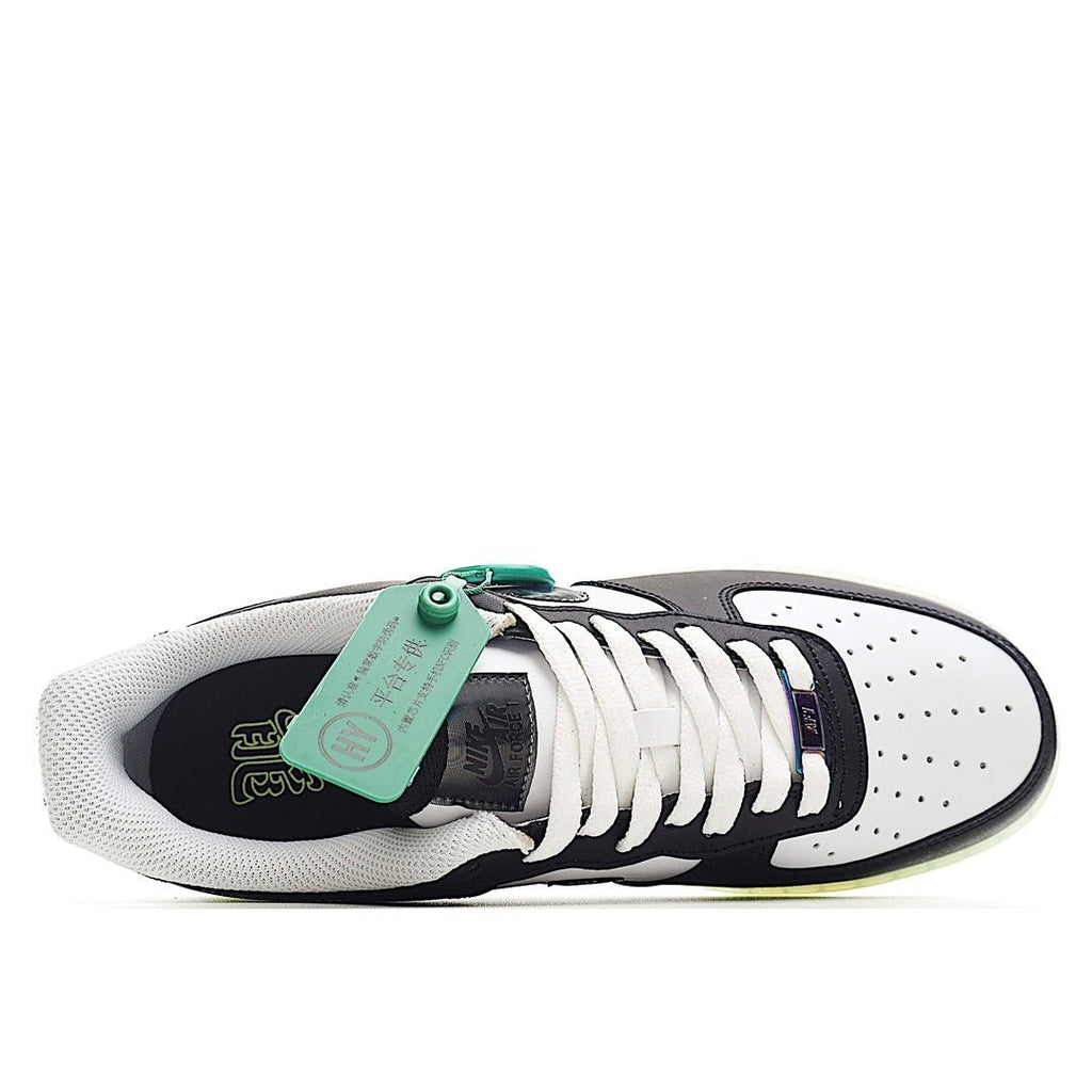 Side view low-top sneaker with white laces, teal tag, black upper, light-olive outsole