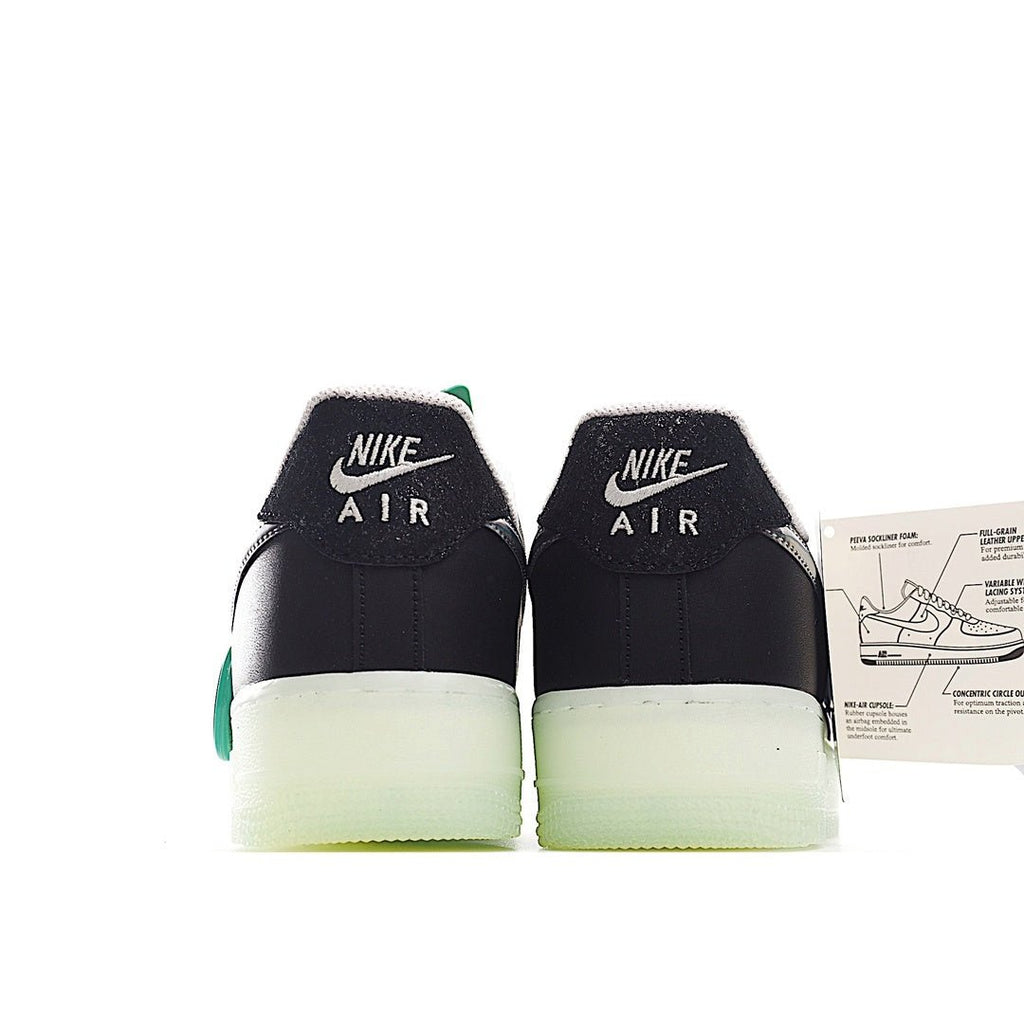Pair of black low-top sneakers with teal lace accents, white detail, light-olive sole