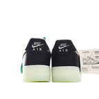 Pair of black low-top sneakers with teal lace accents, white detail, light-olive sole