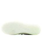 Light-olive sneaker outsole with tread pattern, underside view