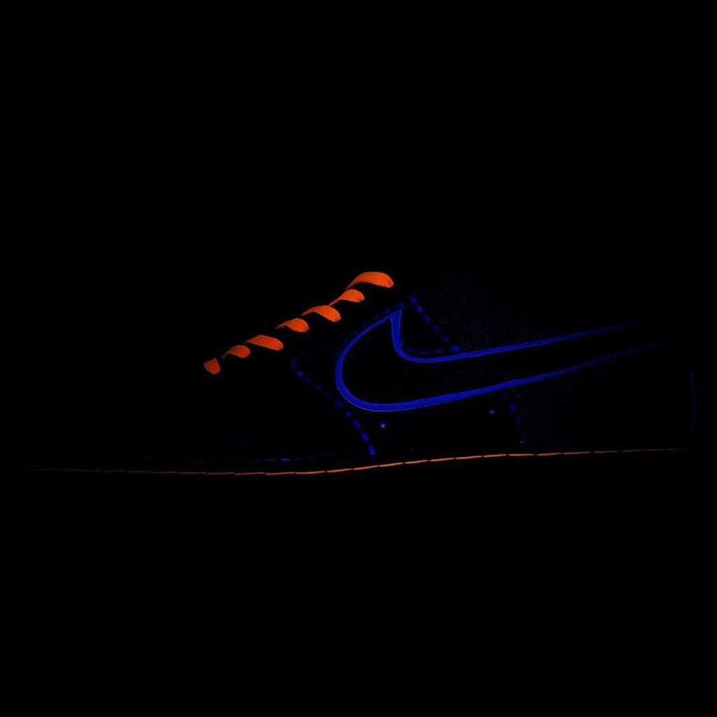 Nike Air Force 1 sneaker with dark blue upper and orange laces