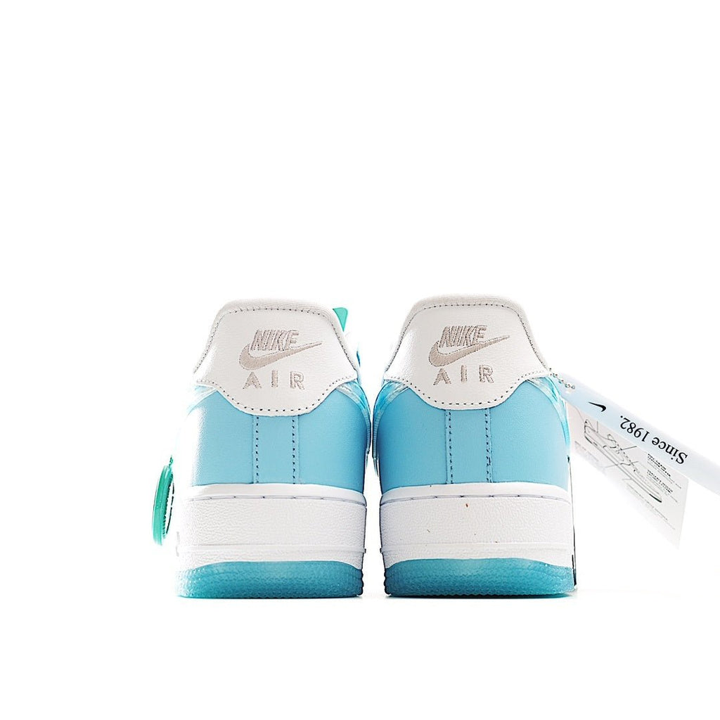 Light blue and white Air Force 1 sneakers, back view with Nike logos