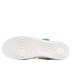 White rubber sneaker outsole with tread pattern and small green accent