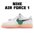 White low-top sneaker with black swoosh, green lace trim, and pink rubber sole