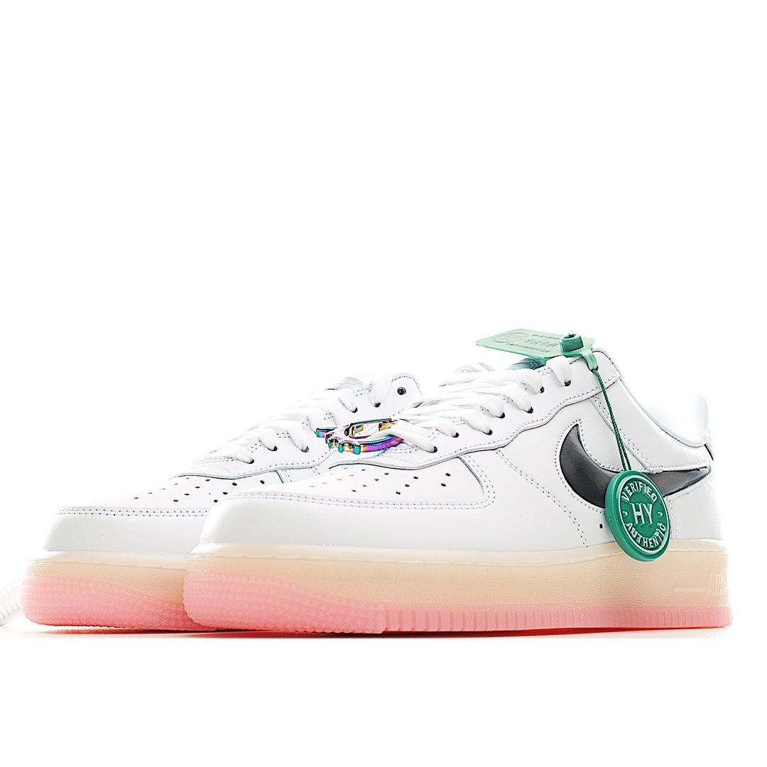 White low-top sneaker side view with green accents, black swoosh, and pink sole