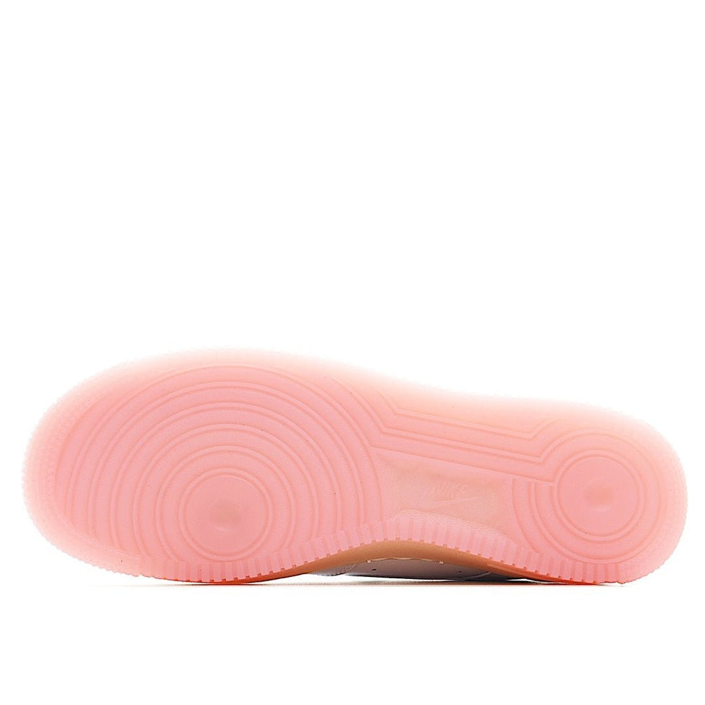 Pink outsole with tread pattern under a white low-top sneaker