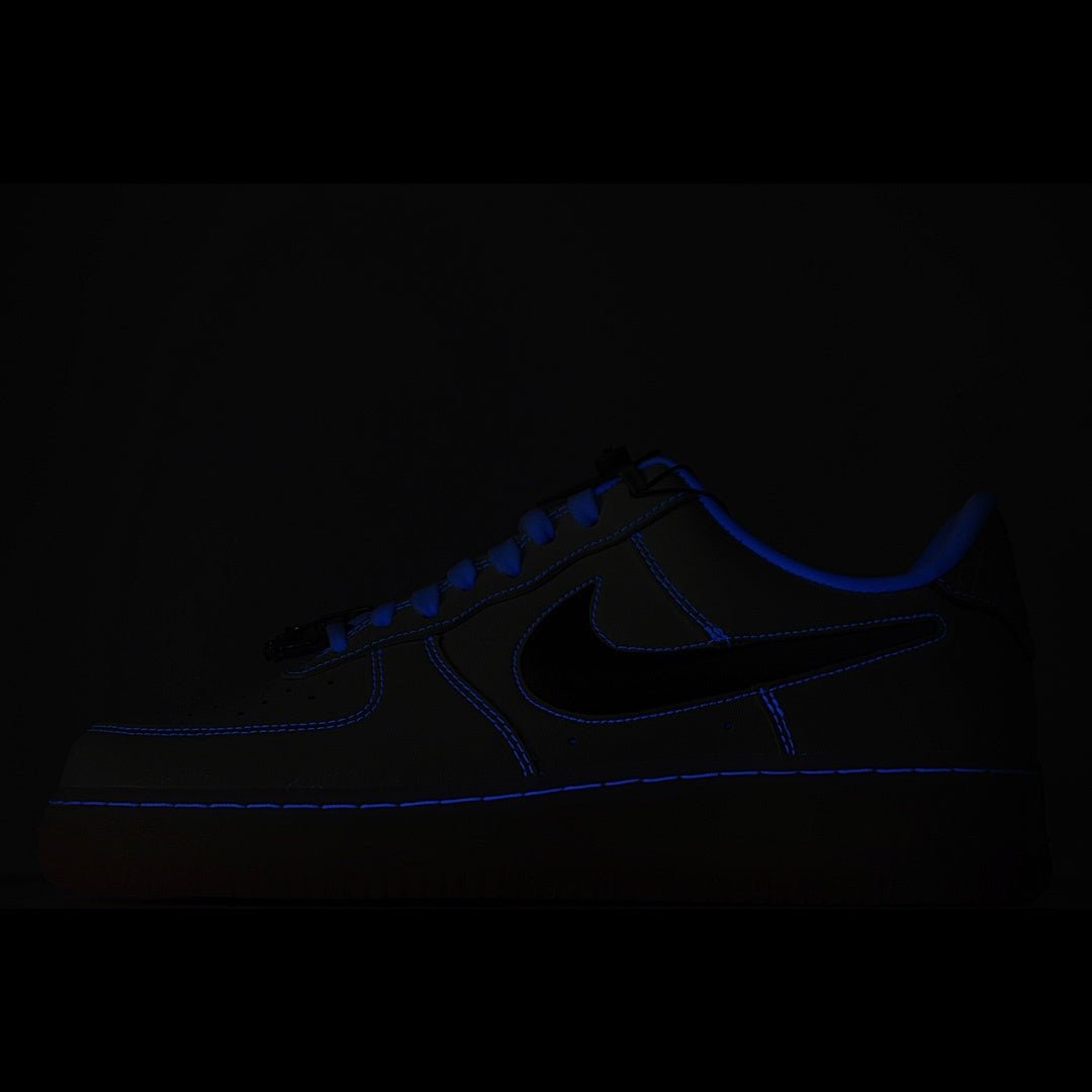 Dark blue low-top sneaker with Nike swoosh and blue laces on black background