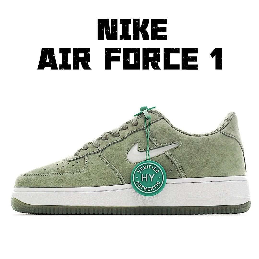Olive suede low-top sneaker with white sole, teal laces, and circular hang tag