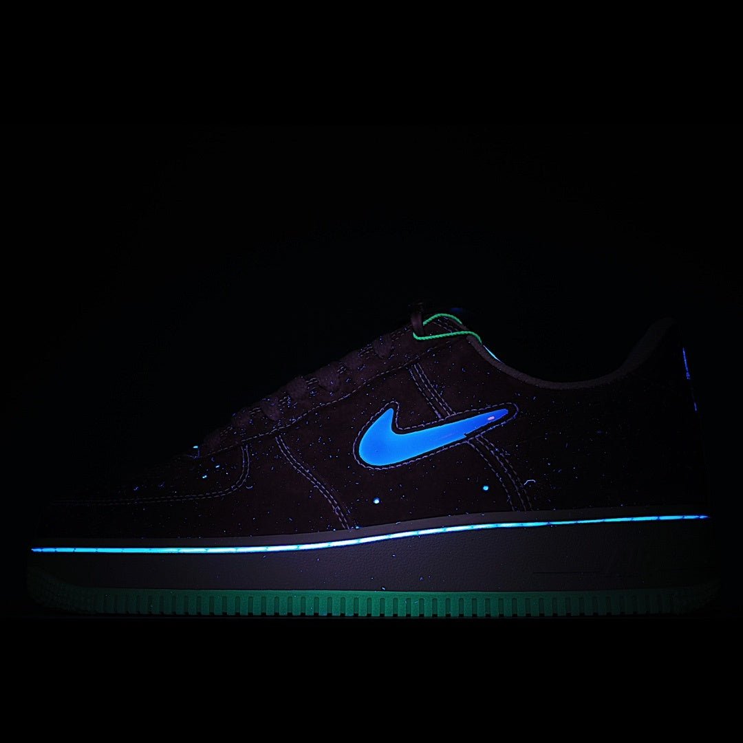 Dark Nike sneaker with neon blue swoosh and glowing outsole, low-top style