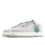 Light gray low-top sneakers with green lace tag, Nike swoosh, white rubber sole