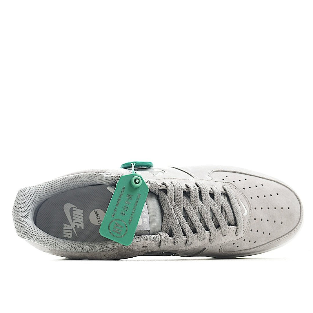 Light gray sneakers interior view with green lace tag and white midsole