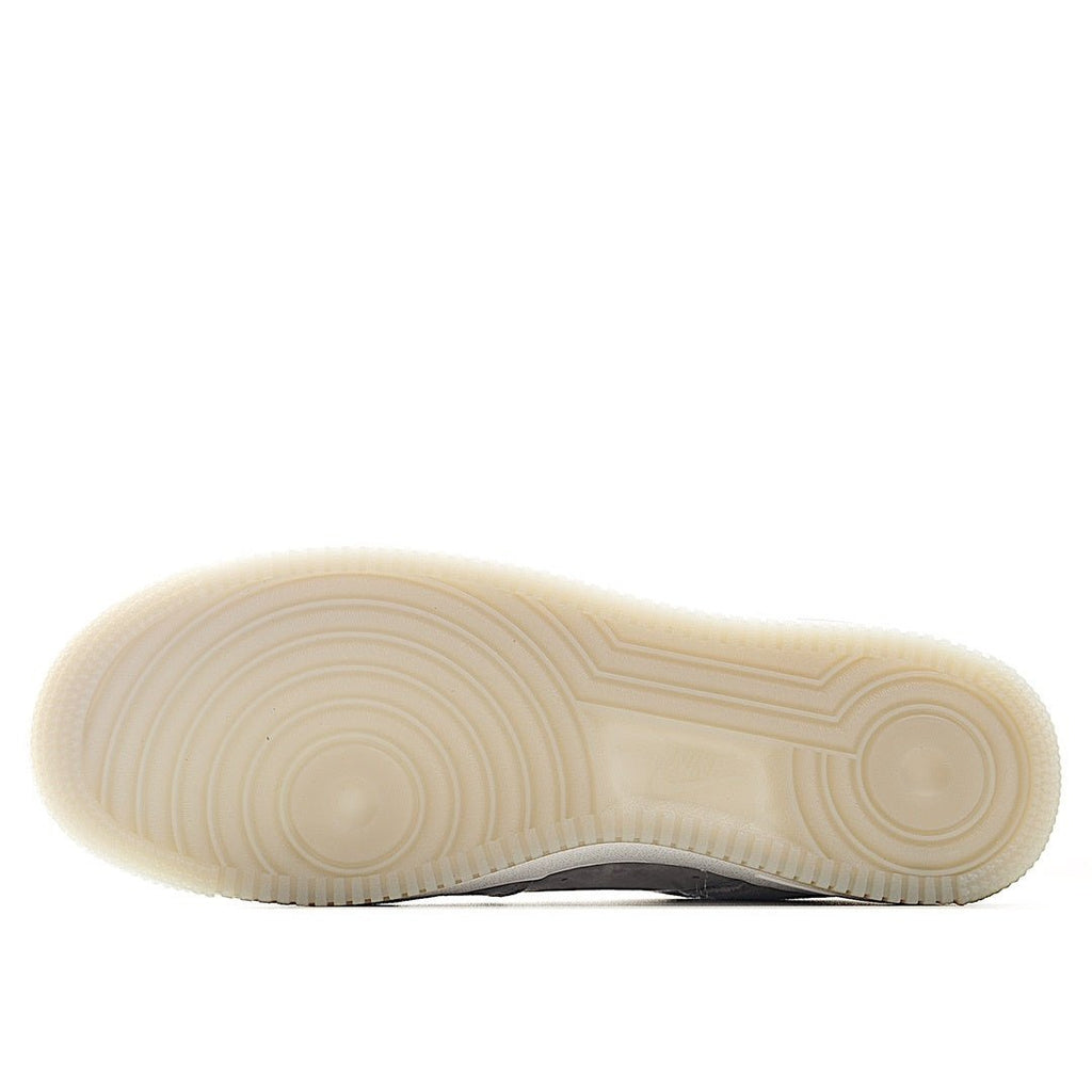 Light gray sneaker outsole with textured tread and white rubber base