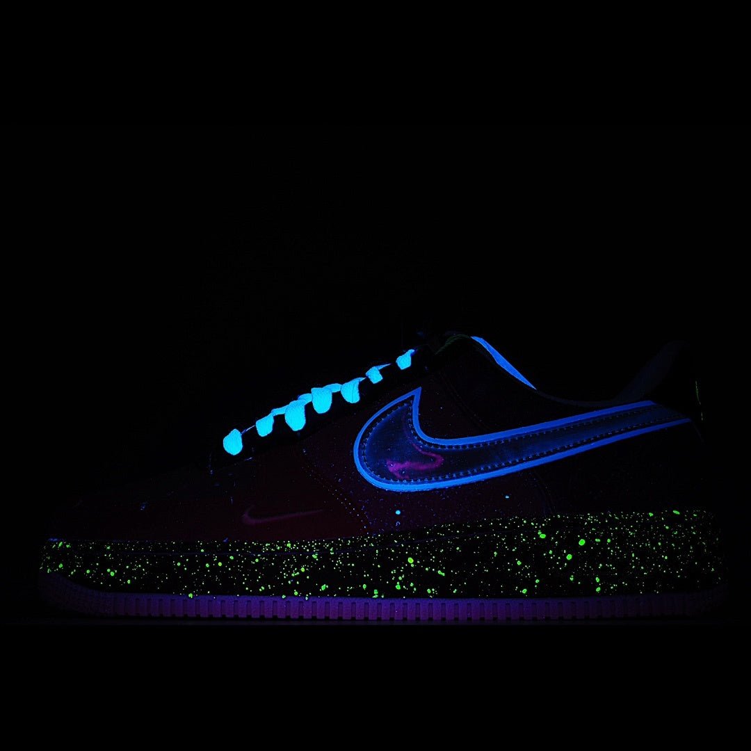 Low-top sneaker with blue swoosh and speckled midsole on a dark outsole