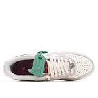 Low-top sneaker open collar showing white laces and dark interior with attached tag.