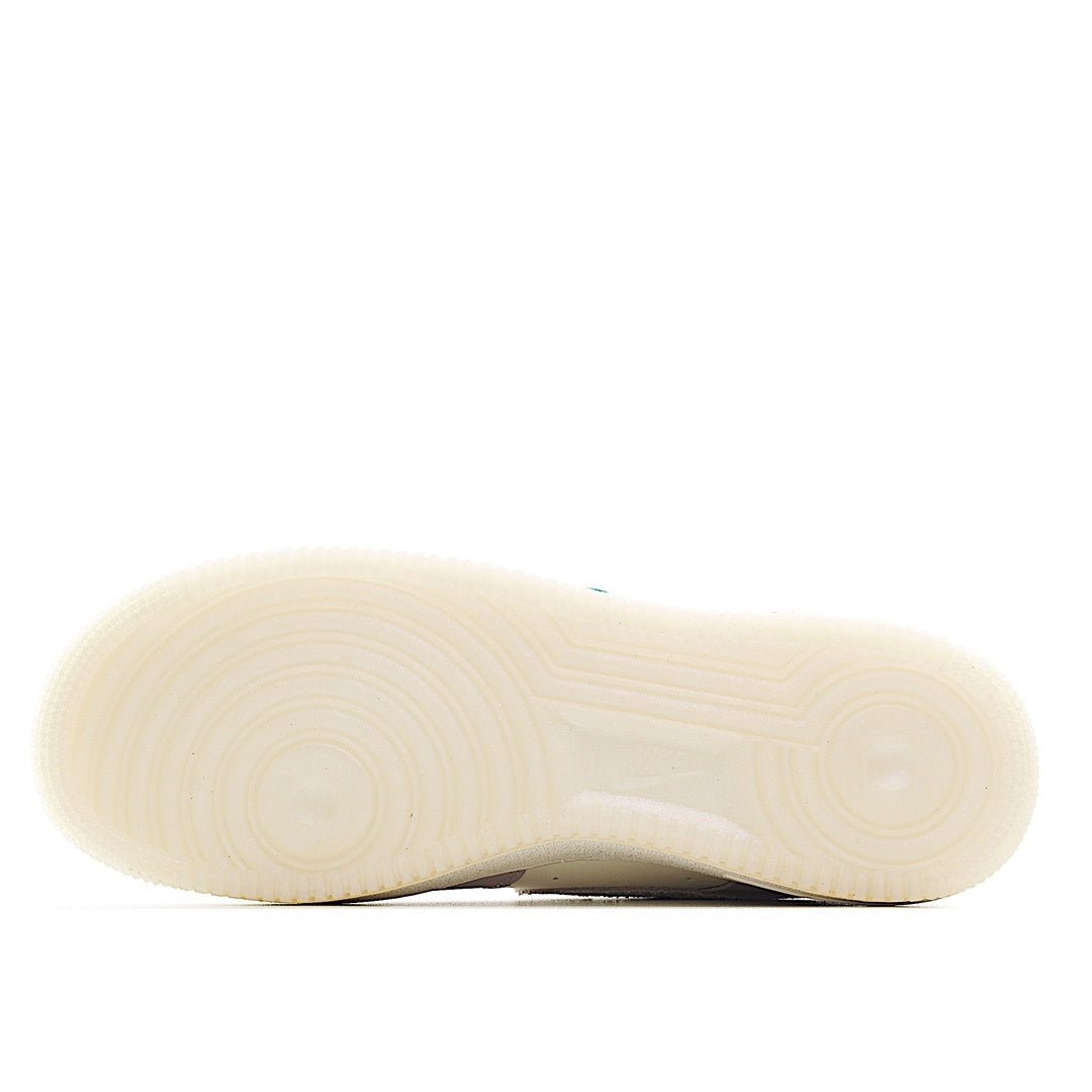 Shoe outsole in light cream rubber with a textured tread pattern.