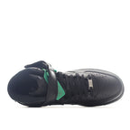 Dark gray/black high-top sneaker shown from side with green tongue detail and laces