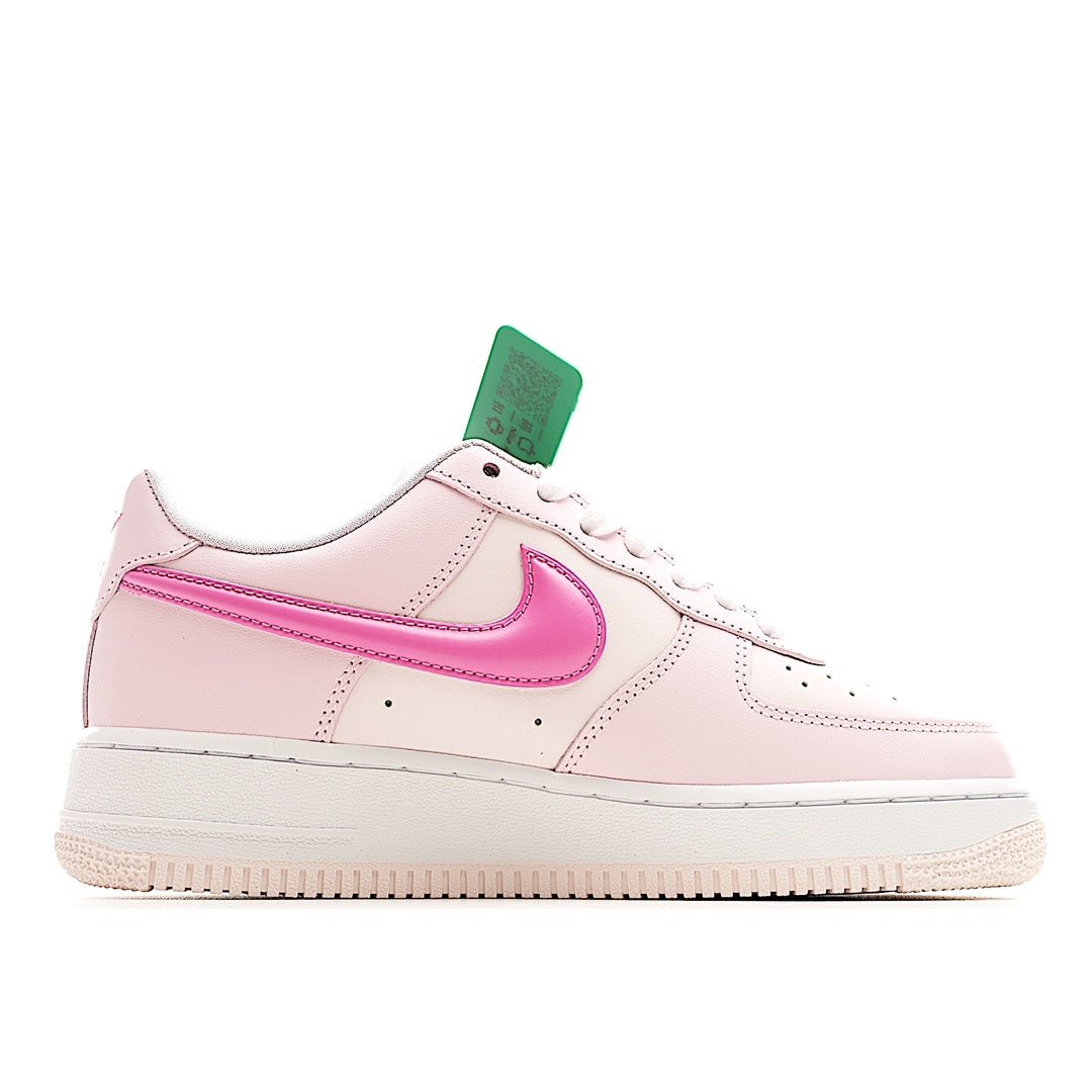 Pink and white low-top sneakers with pink swoosh and green hang tag