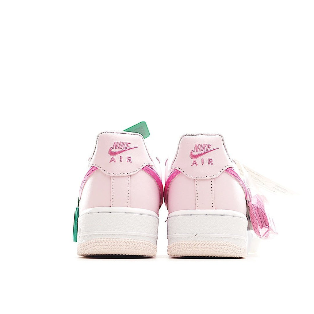 Pair of pink and white low-top sneakers, rear view with Nike Air text