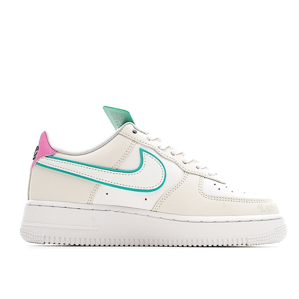 White low-top sneaker with teal swoosh and pink heel accent, lace-up