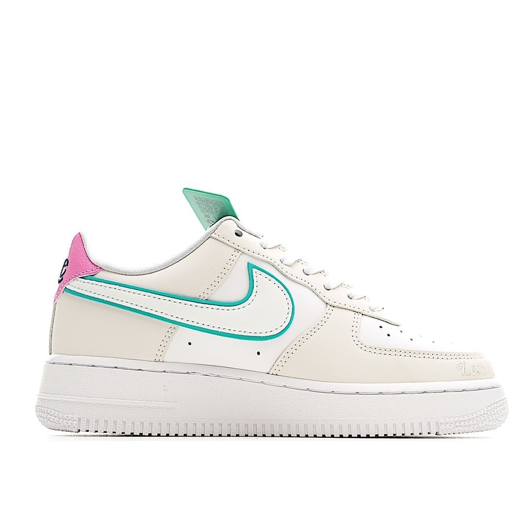 White low-top sneaker with teal swoosh and pink heel accent, lace-up