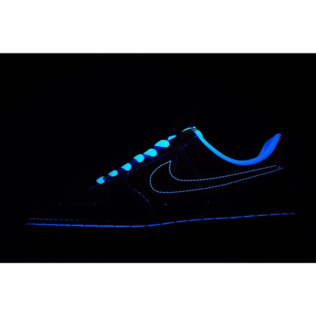 Low-top sneaker with dark upper and blue glowing swoosh accents