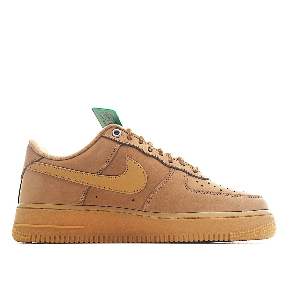 Tan Nike low-top sneaker with teal heel tab and side swoosh detail
