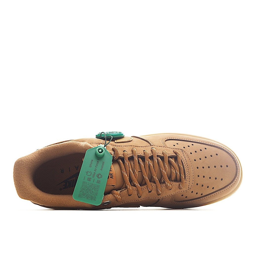 Nike sneaker with tan interior and teal green hang tag on the tongue