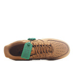 Nike sneaker with tan interior and teal green hang tag on the tongue