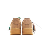 Back view of tan Nike low-top sneakers with teal heel tabs and AIR text