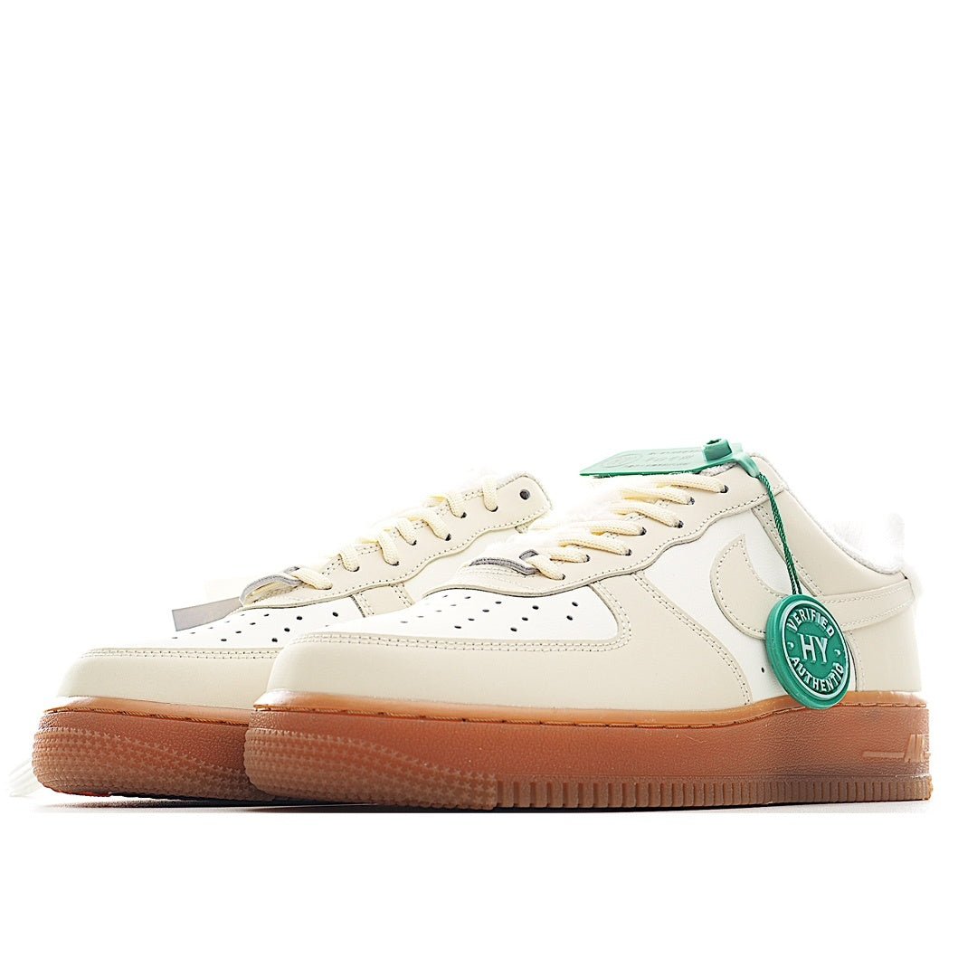 Cream leather low-top sneaker, green lace lock tag, tan gum sole