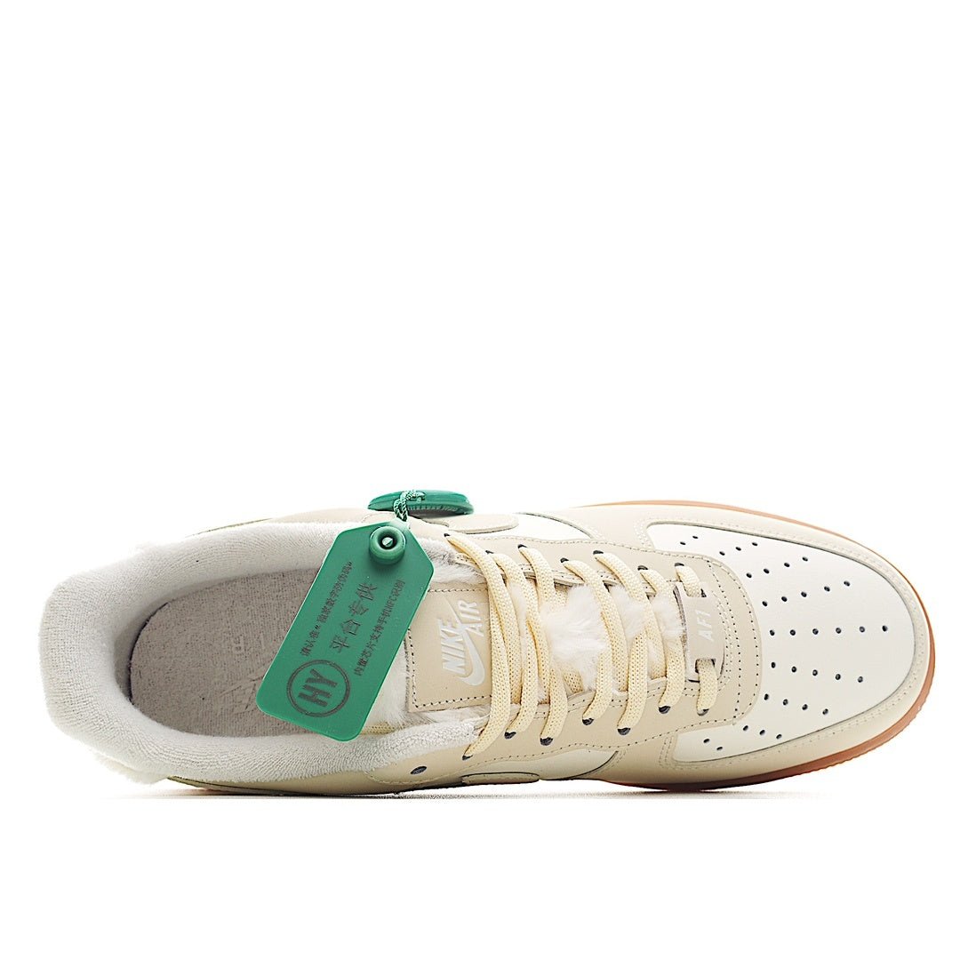 Cream leather low-top sneaker with green size tag and off-white interior lining