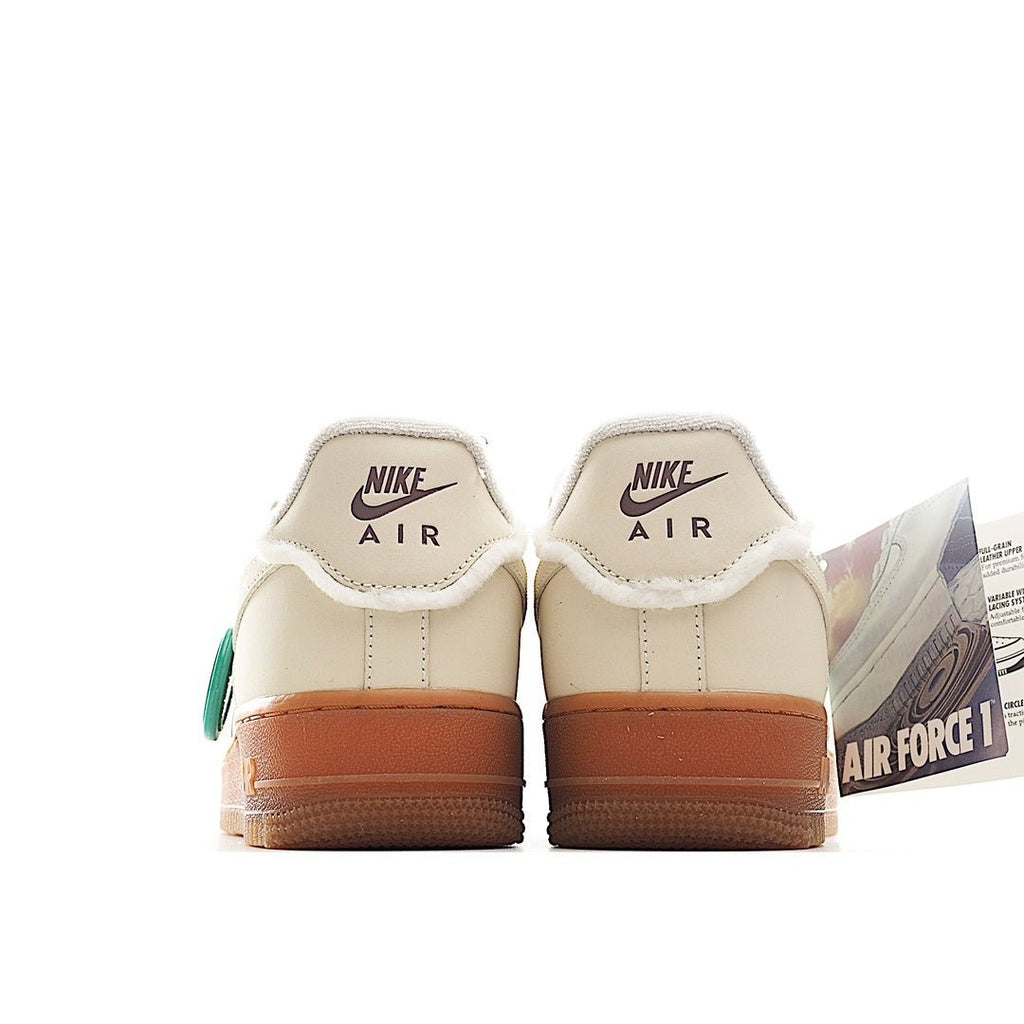 Cream leather low-top sneaker with Nike Air heel text and tan gum outsole