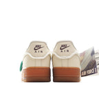Cream leather low-top sneaker with Nike Air heel text and tan gum outsole