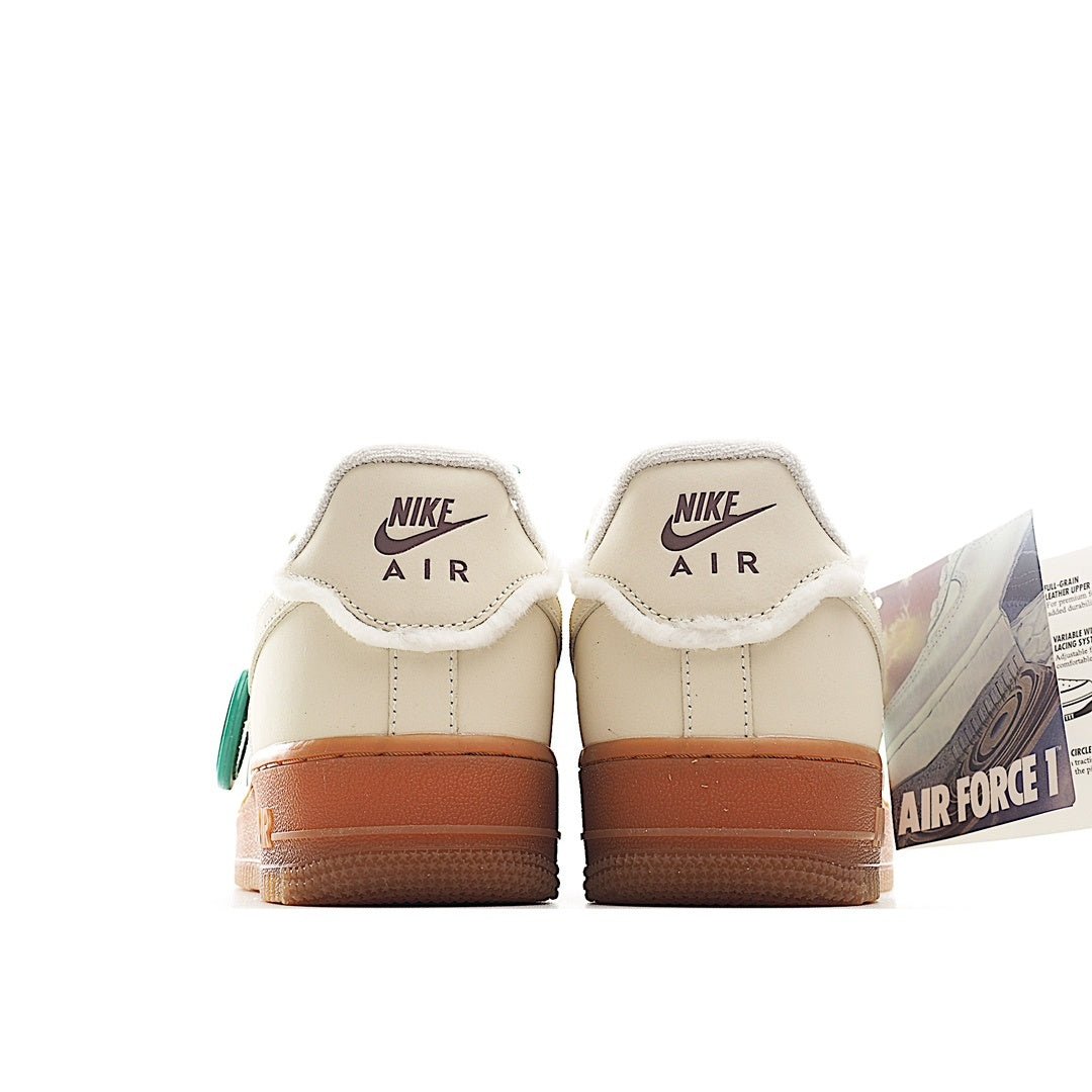 Cream leather low-top sneaker with Nike Air heel text and tan gum outsole