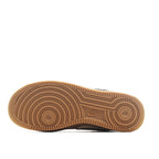 Brown rubber sneaker outsole with circular tread pattern and Nike logo