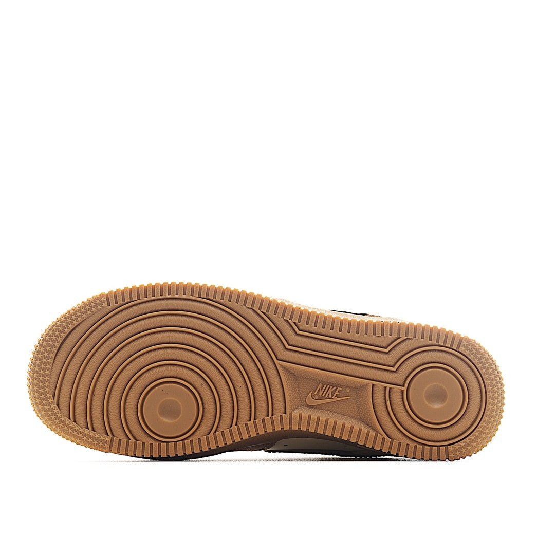 Brown rubber sneaker outsole with circular tread pattern and Nike logo