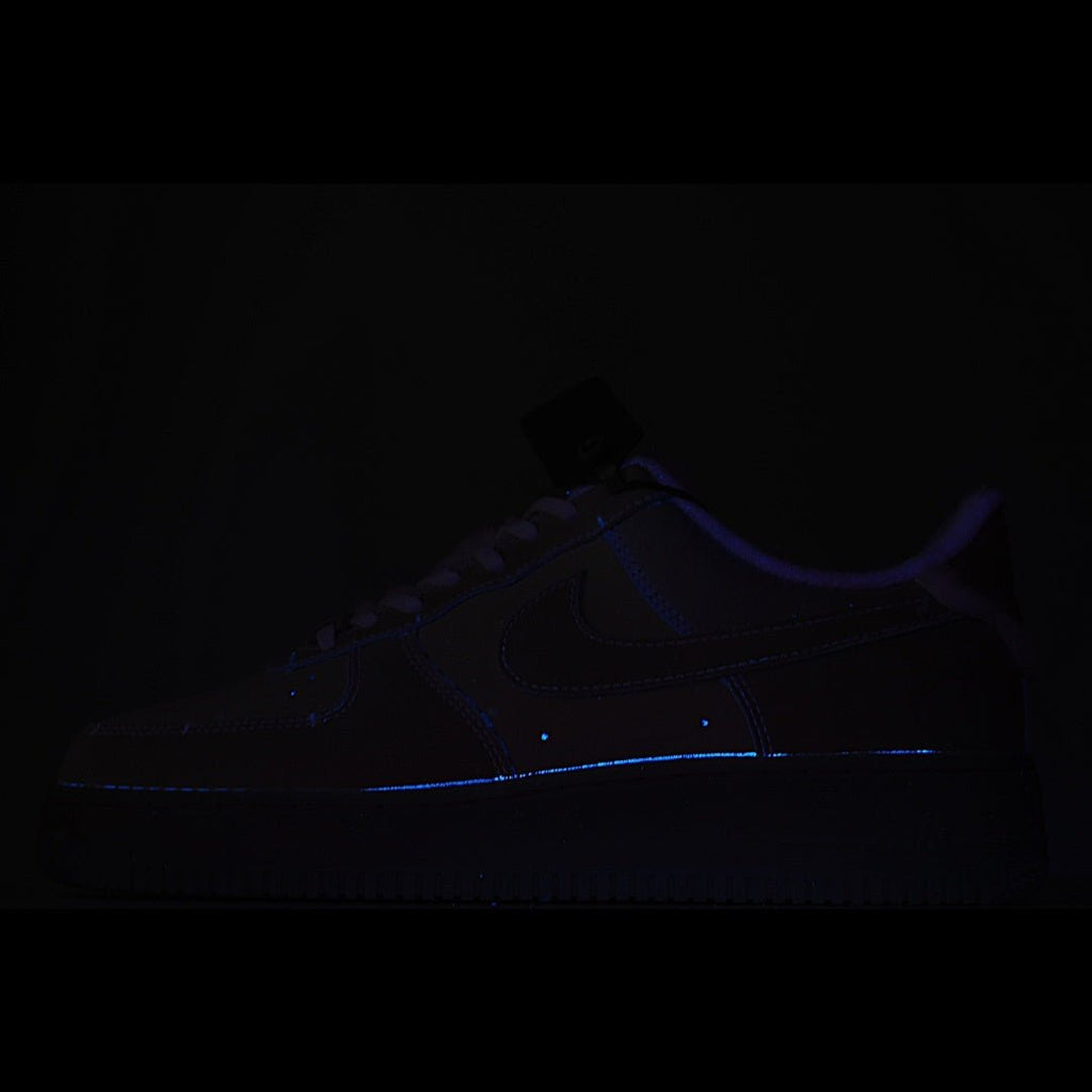Dark low-top sneaker with faint blue glowing trim