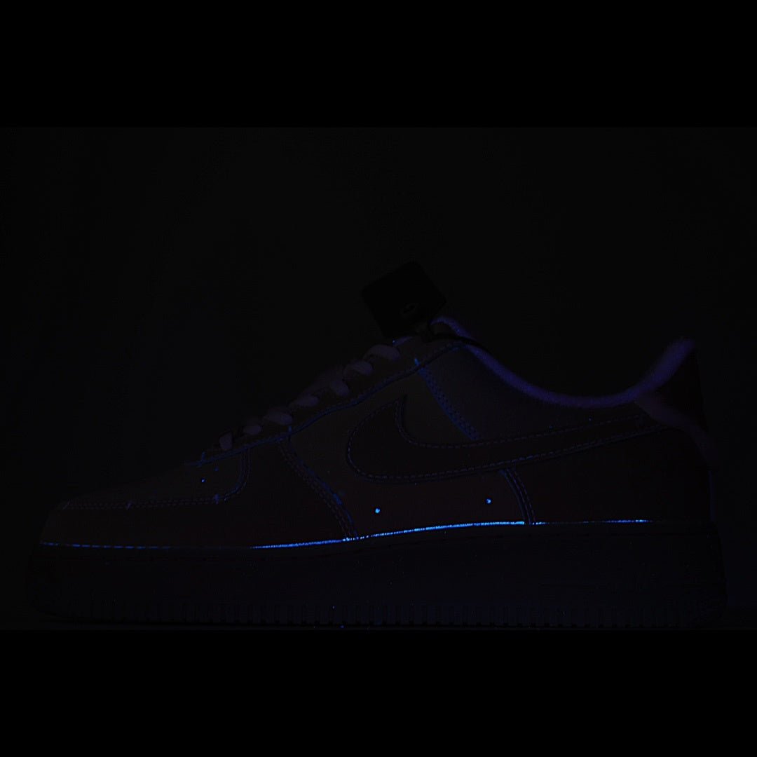 Dark low-top sneaker with faint blue glowing trim