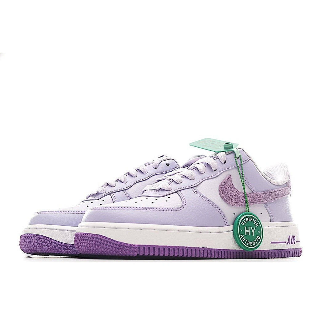 Pair of lavender low-top sneakers with white laces and purple outsole, side view