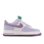 Lavender low-top sneaker with white sole, purple outsole, and green-tinted heel tab