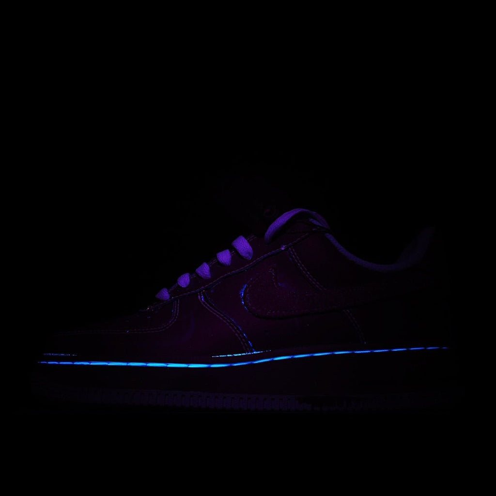 Dark purple low-top sneakers with blue glowing trim and lace-up front