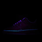 Dark purple low-top sneakers with blue glowing trim and lace-up front