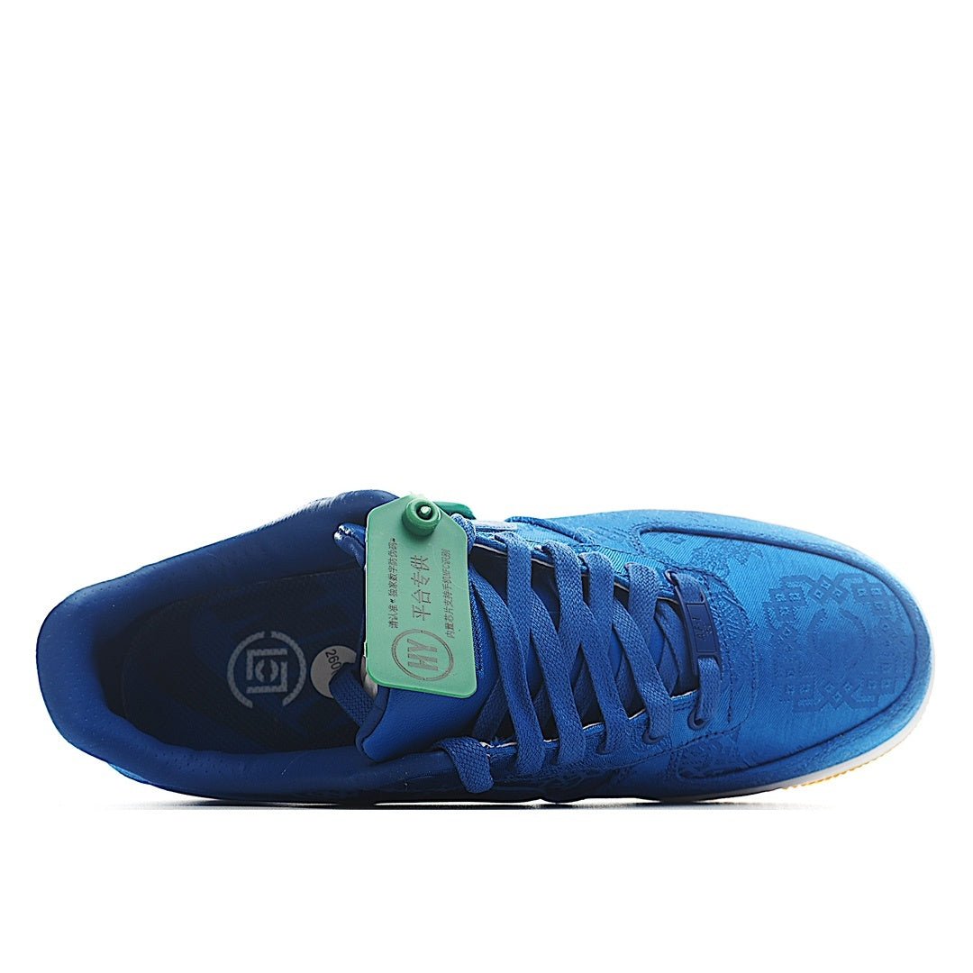 Blue Nike Air Force 1 sneaker with lace-up front, white midsole, green heel tag.
